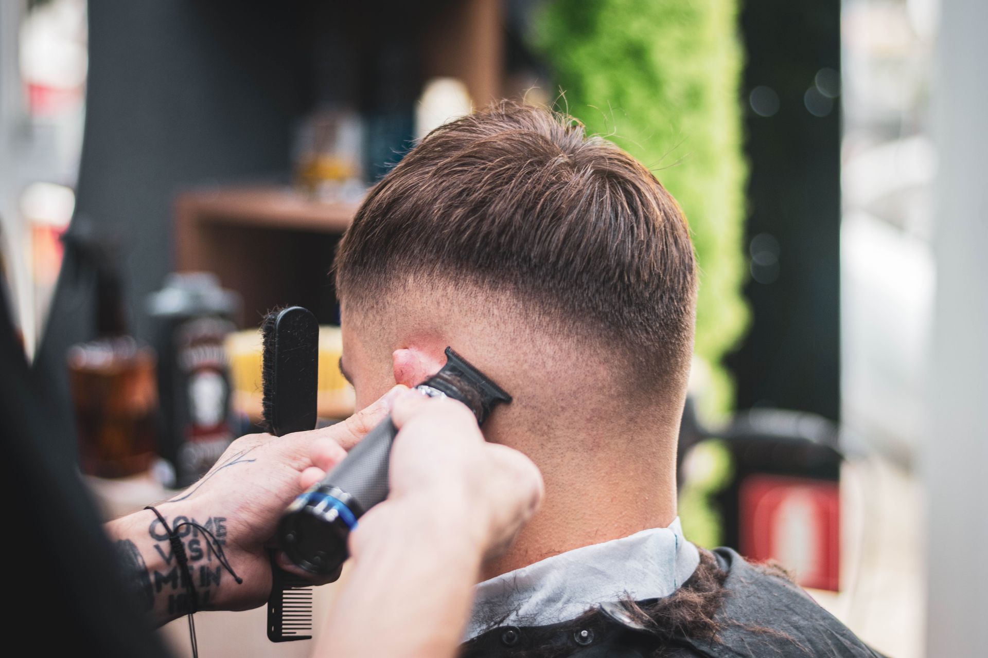 Barber performing a precision cut at Apex Barbershop Studio